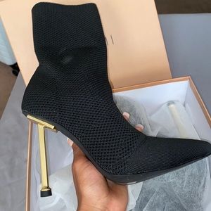 These ankle high heel boots are black with knitted designs/fabric NEVER WORN